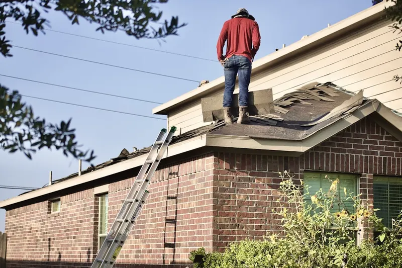 Professional roofer working on a residential roof in Trebein
